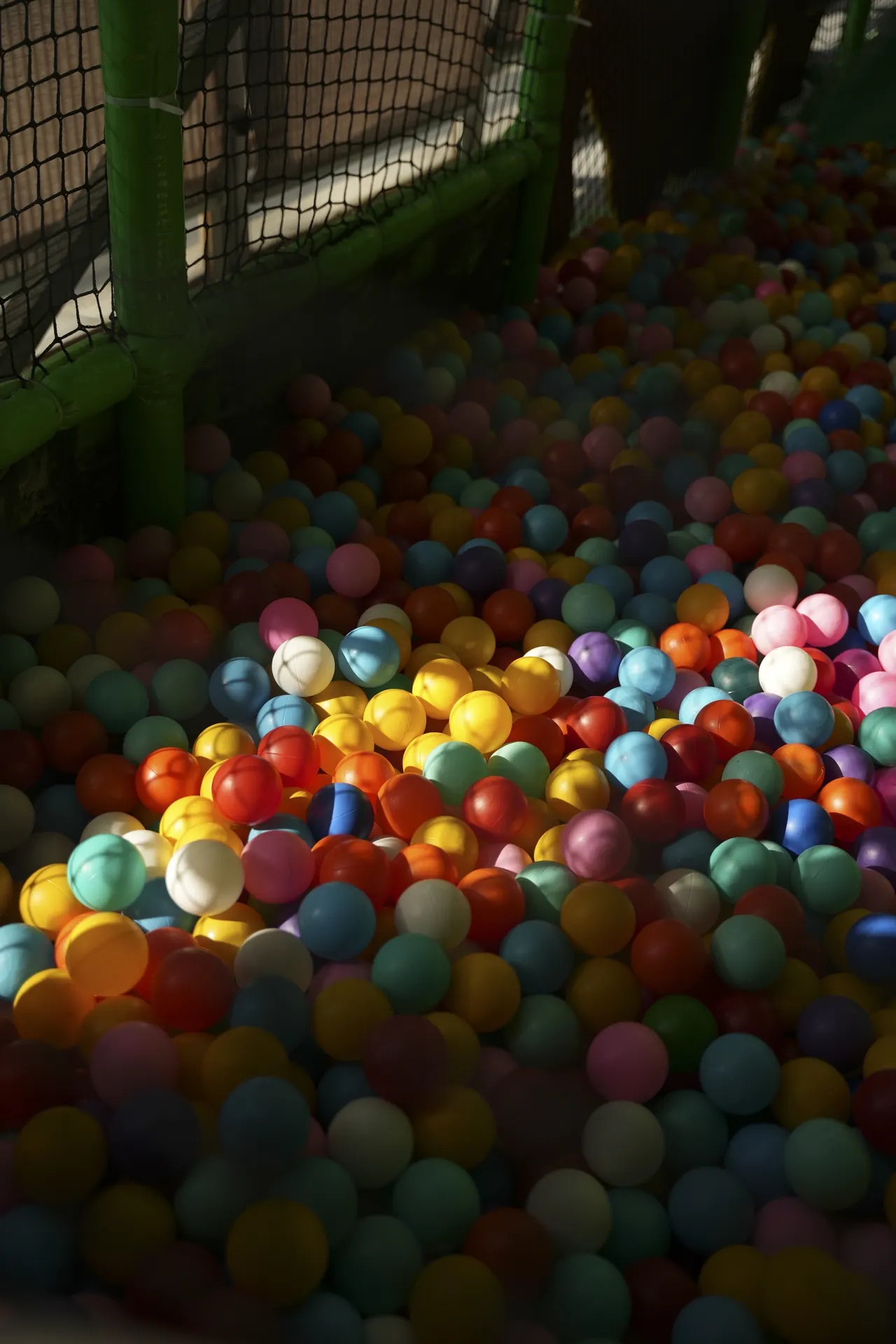A deep ball pit full of bright plastic balls