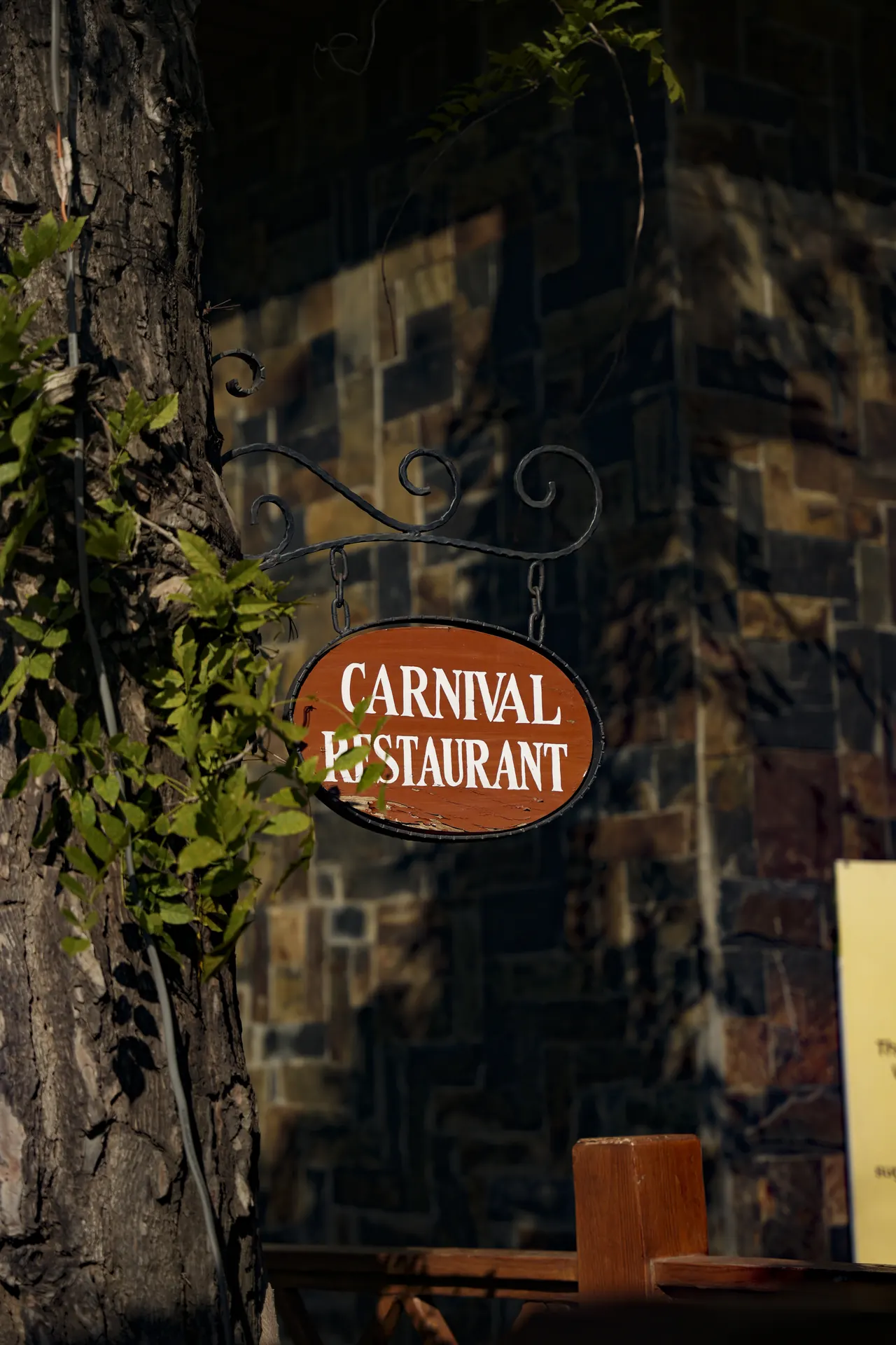 The Carnival Restaurant sign on a stone wall