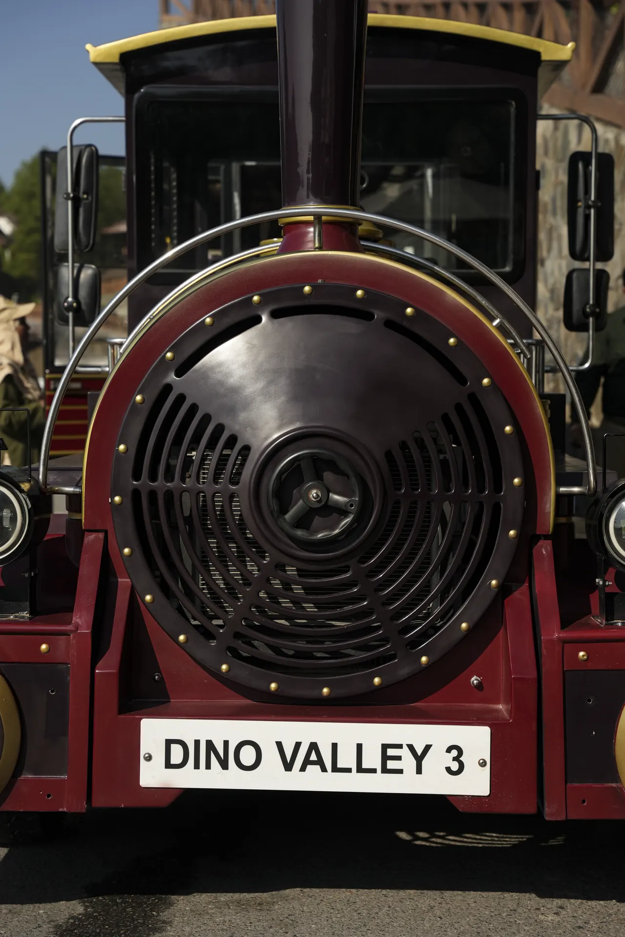 The red Dino Valley road train with a big black engine grille